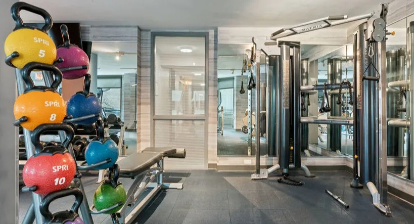 Fitness center area with a colorful kettlebell rack and strength training equipment at Elm Street Plaza Chicago