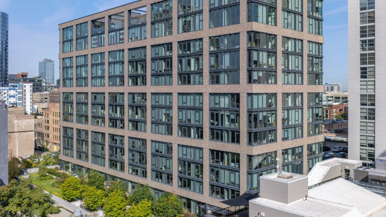 Aerial view of the modern EMME Chicago apartment building exterior, showcasing its architecture and surrounding cityscape