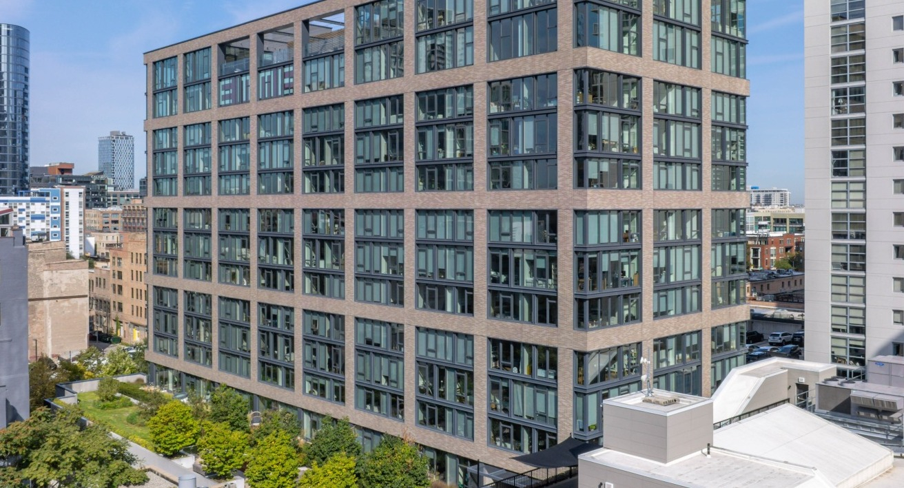 Aerial view of the modern EMME Chicago apartment building exterior, showcasing its architecture and surrounding cityscape