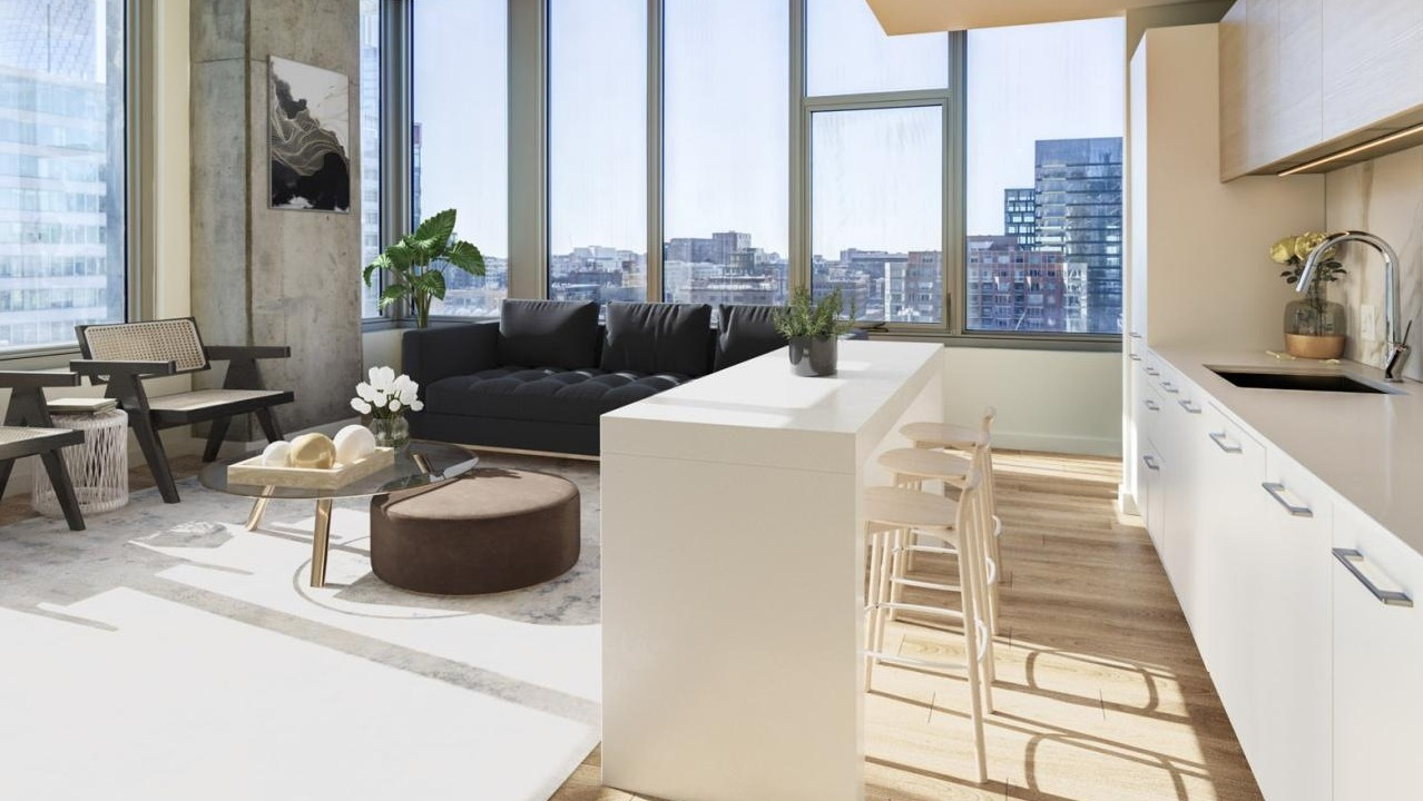 Chic open-concept kitchen and living area with a breakfast bar, modern seating, and large windows overlooking city views at EMME Chicago in Chicago