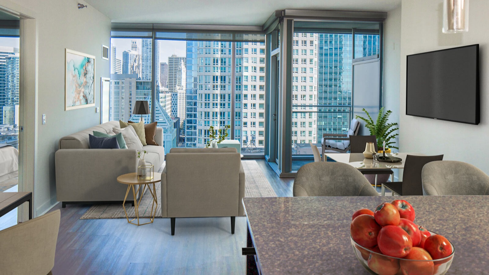 Env Chicago living and dining combination area with comfortable seating and expansive city views from large windows