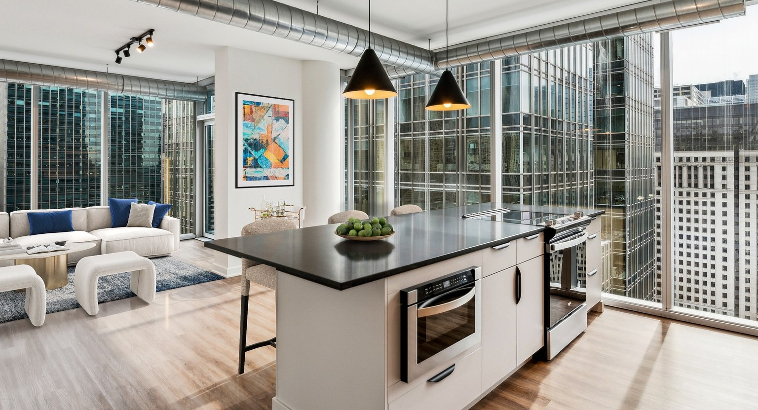 Env Chicago luxury kitchen with a large island, premium appliances, and floor-to-ceiling windows overlooking the city