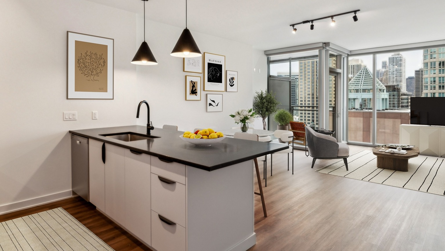 Modern kitchen and dining area in an Env Chicago apartment, with sleek appliances and city views from large windows