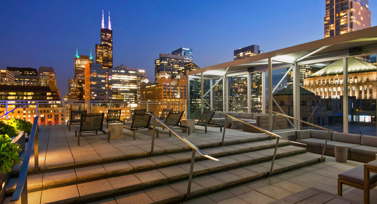 Env Chicago rooftop terrace featuring stylish outdoor seating and an expansive cityscape at twilight