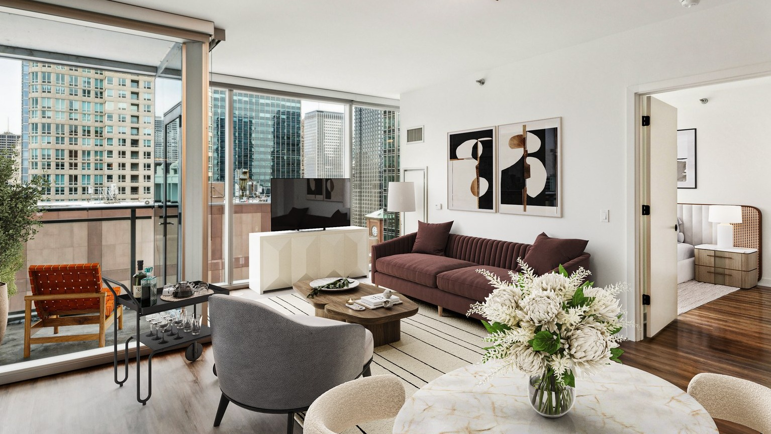 Env Chicago spacious living room with plush seating, modern decor, and a balcony offering city skyline views