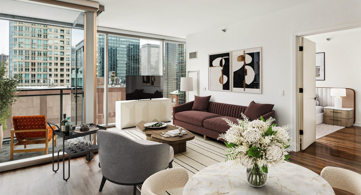 Env Chicago spacious living room with plush seating, modern decor, and a balcony offering city skyline views