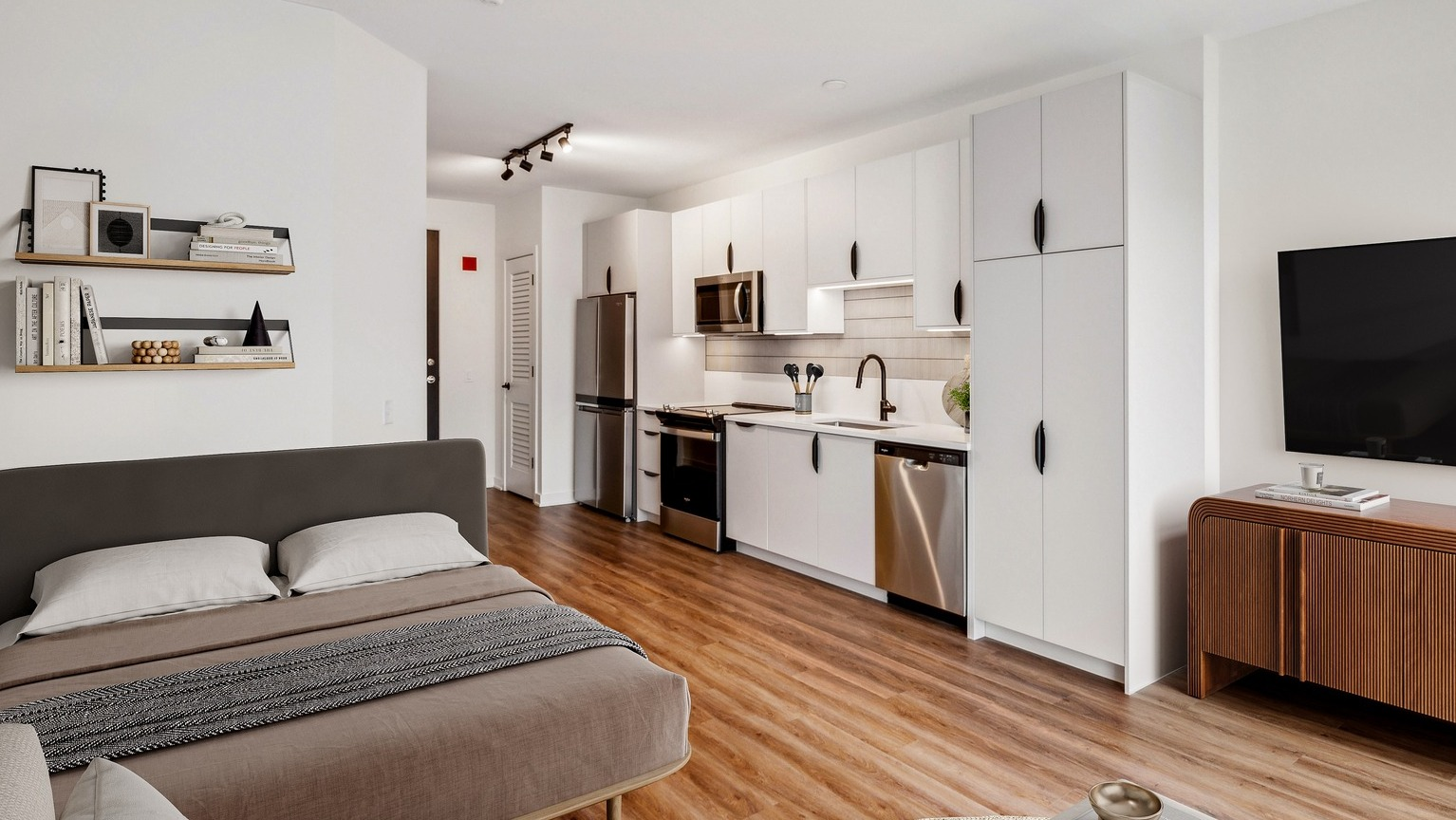 Env Chicago studio apartment with a functional kitchen, cozy sleeping area, and hardwood floors for city living