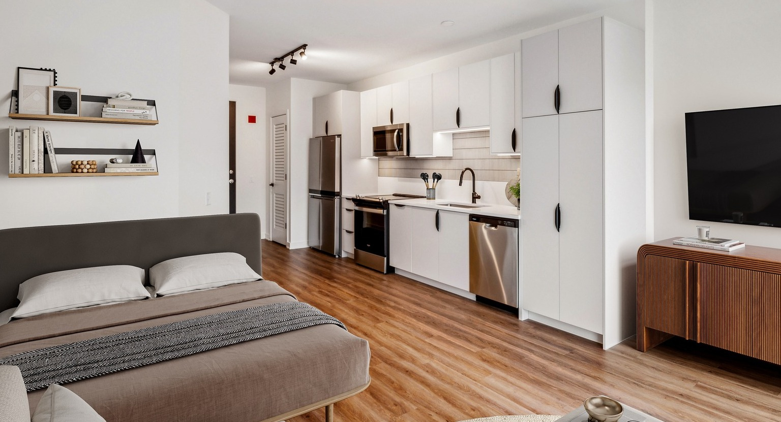 Env Chicago studio apartment with a functional kitchen, cozy sleeping area, and hardwood floors for city living