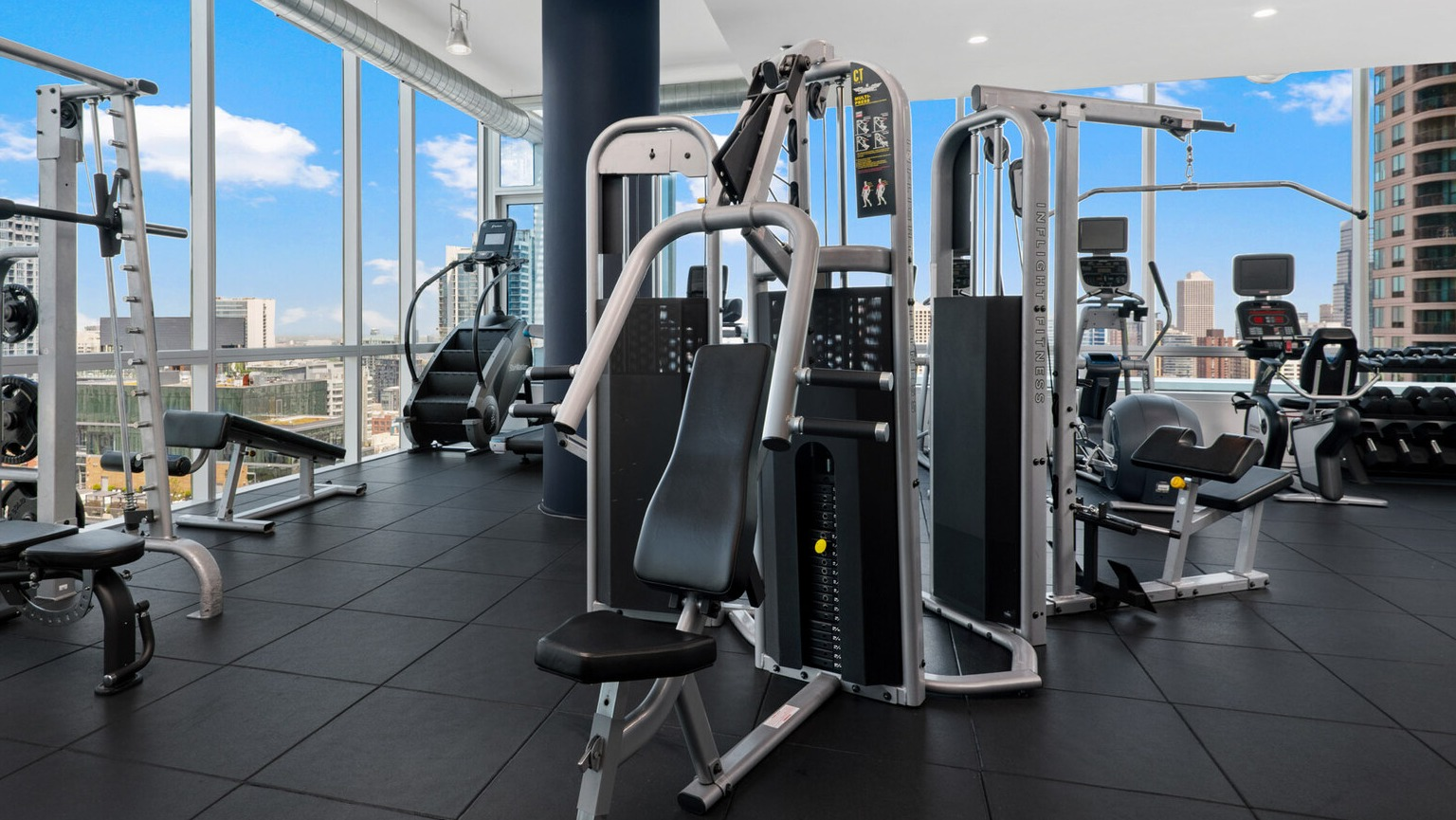 Env Chicago weight room featuring extensive strength training equipment and bright, natural light from large windows