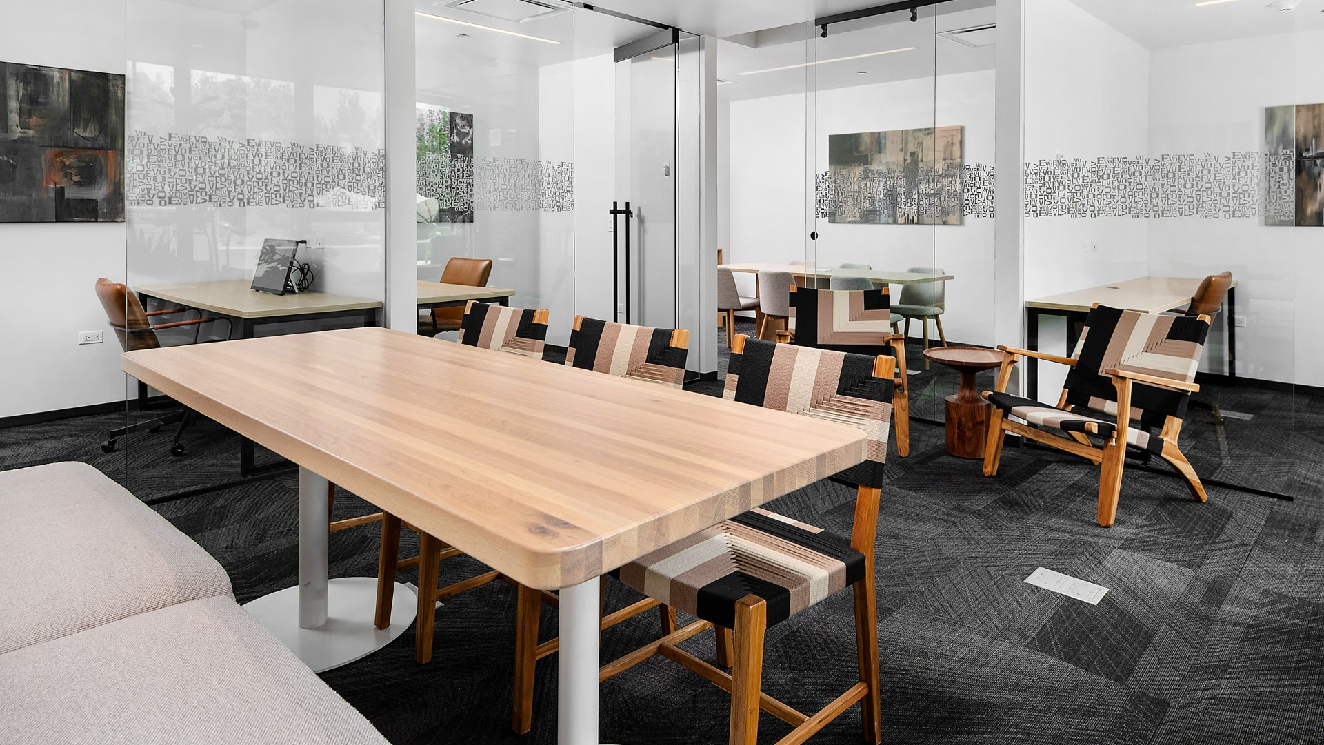 Modern co-working space at Evo Union Park in Chicago, featuring private meeting rooms and collaborative work areas with contemporary furniture