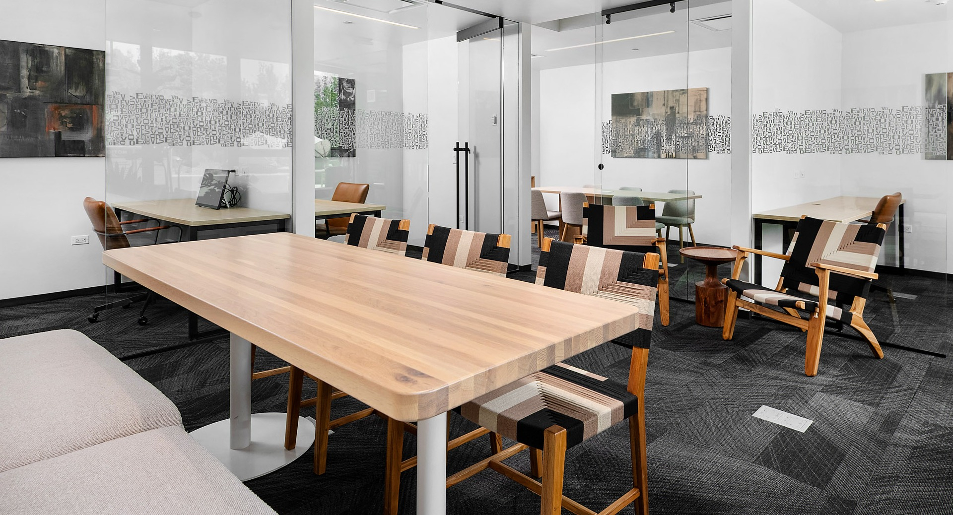 Modern co-working space at Evo Union Park in Chicago, featuring private meeting rooms and collaborative work areas with contemporary furniture