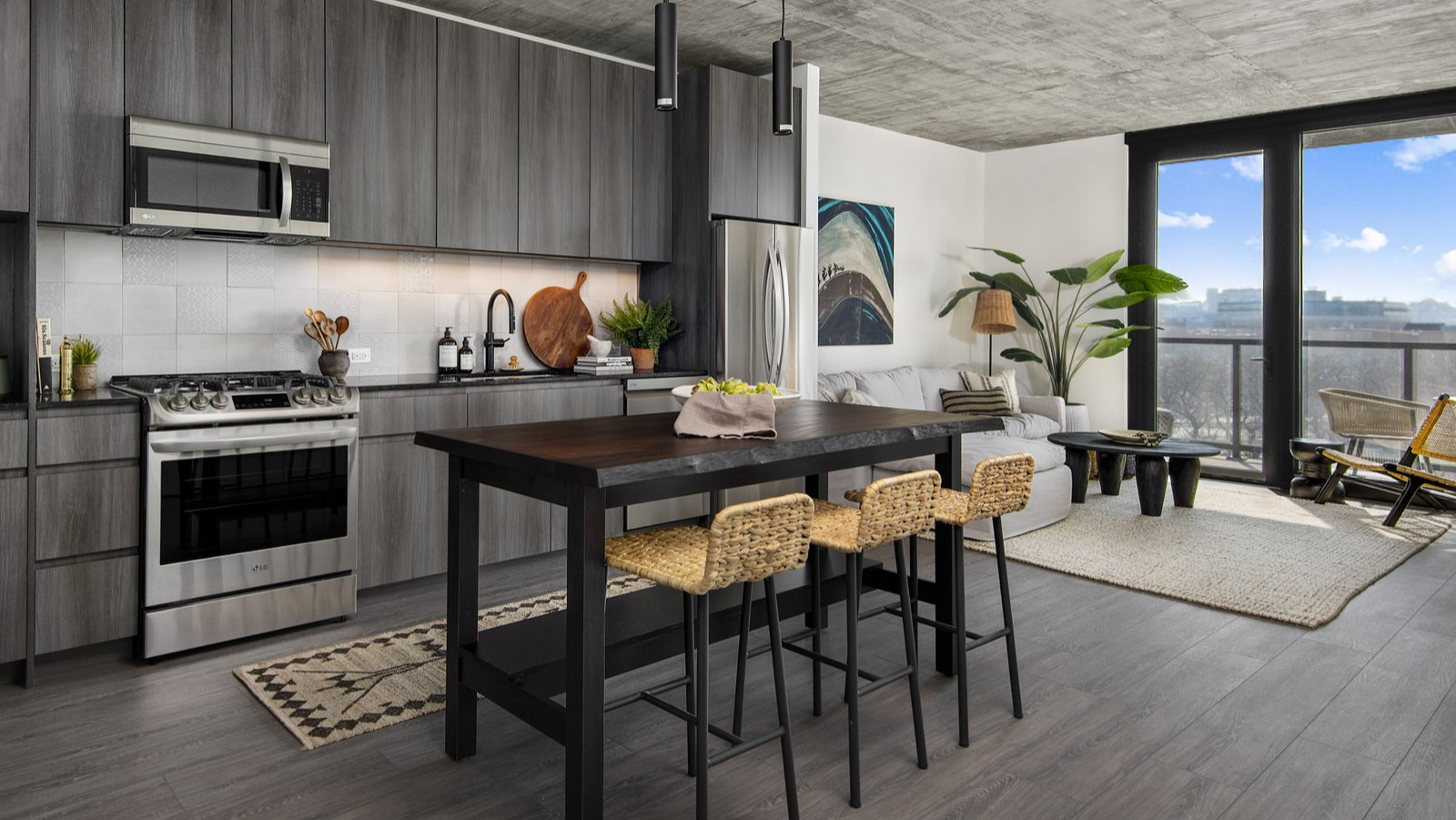 Open-concept apartment layout at Evo Union Park in Chicago, showcasing the seamless flow from the modern kitchen with an island to the inviting living area