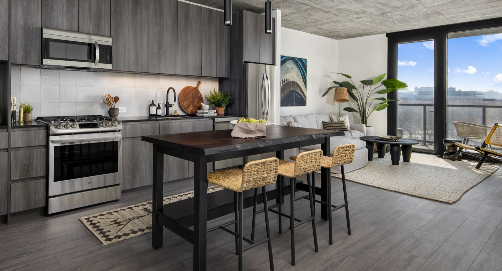 Open-concept apartment layout at Evo Union Park in Chicago, showcasing the seamless flow from the modern kitchen with an island to the inviting living area
