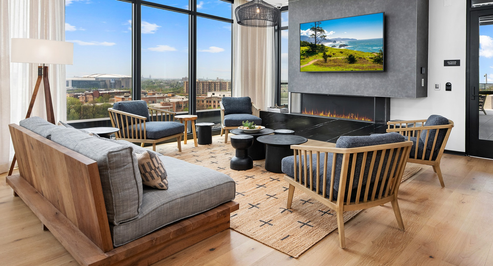 Cozy resident lounge at Evo Union Park in Chicago, featuring a modern fireplace, comfortable seating, and large windows offering city vistas