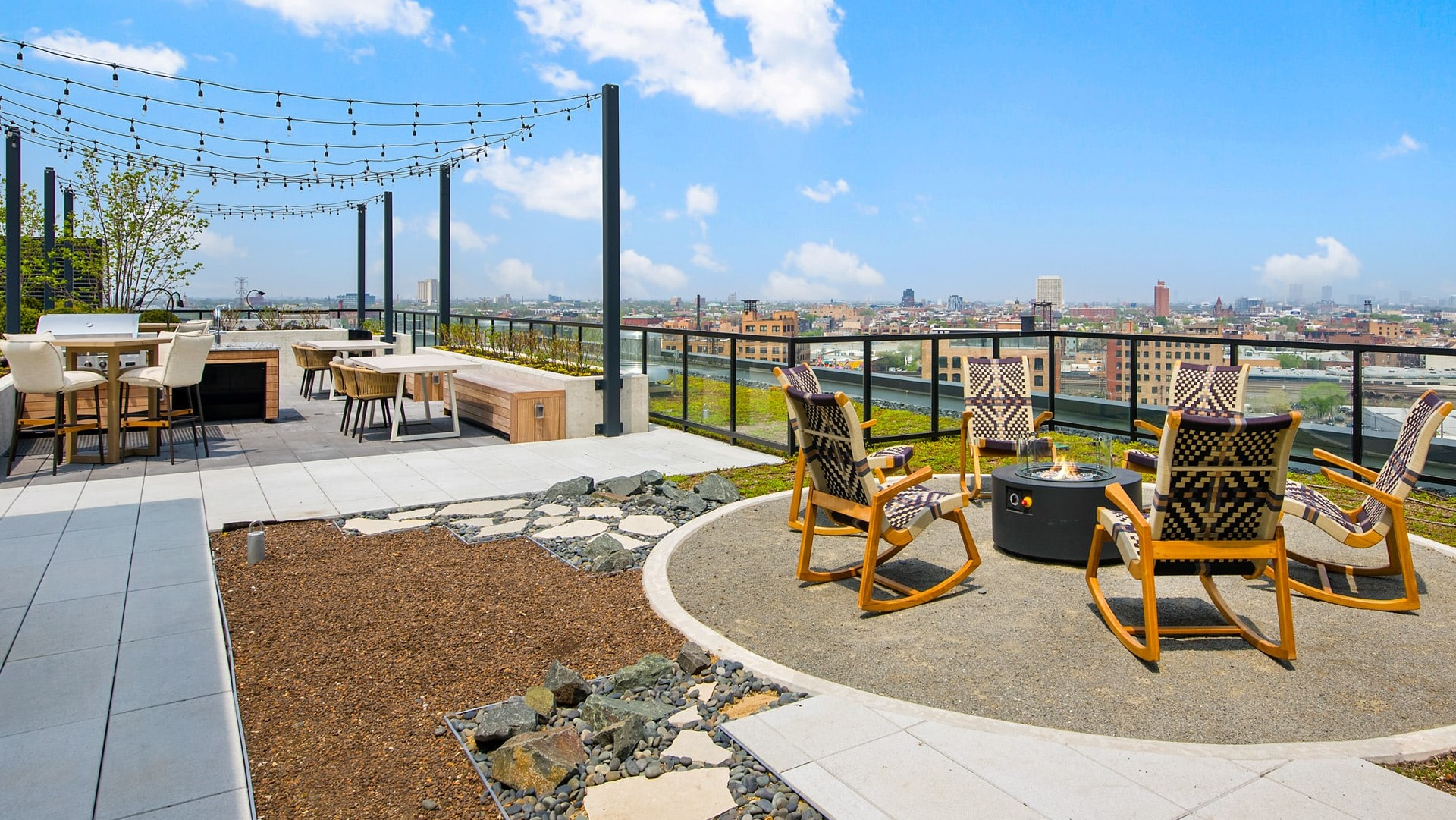 Inviting rooftop fire pit lounge at Evo Union Park in Chicago, surrounded by comfortable chairs and city skyline views, perfect for evenings