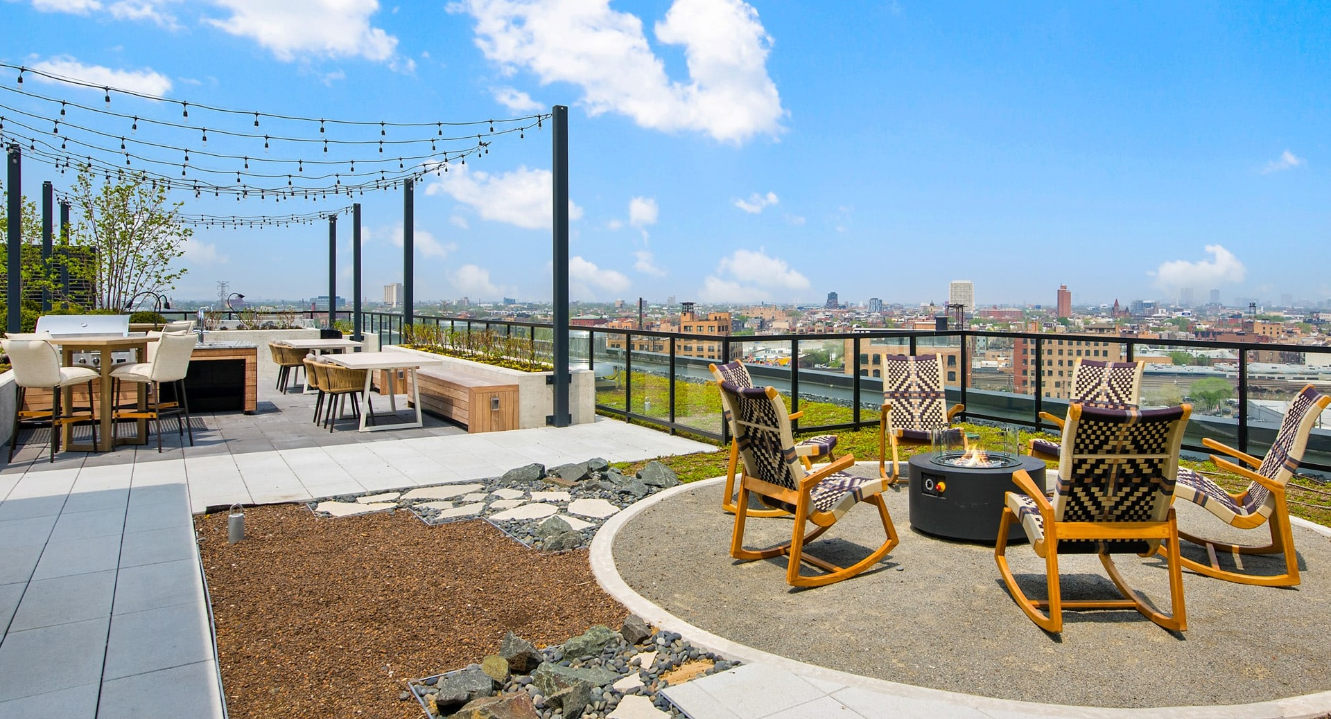 Inviting rooftop fire pit lounge at Evo Union Park in Chicago, surrounded by comfortable chairs and city skyline views, perfect for evenings