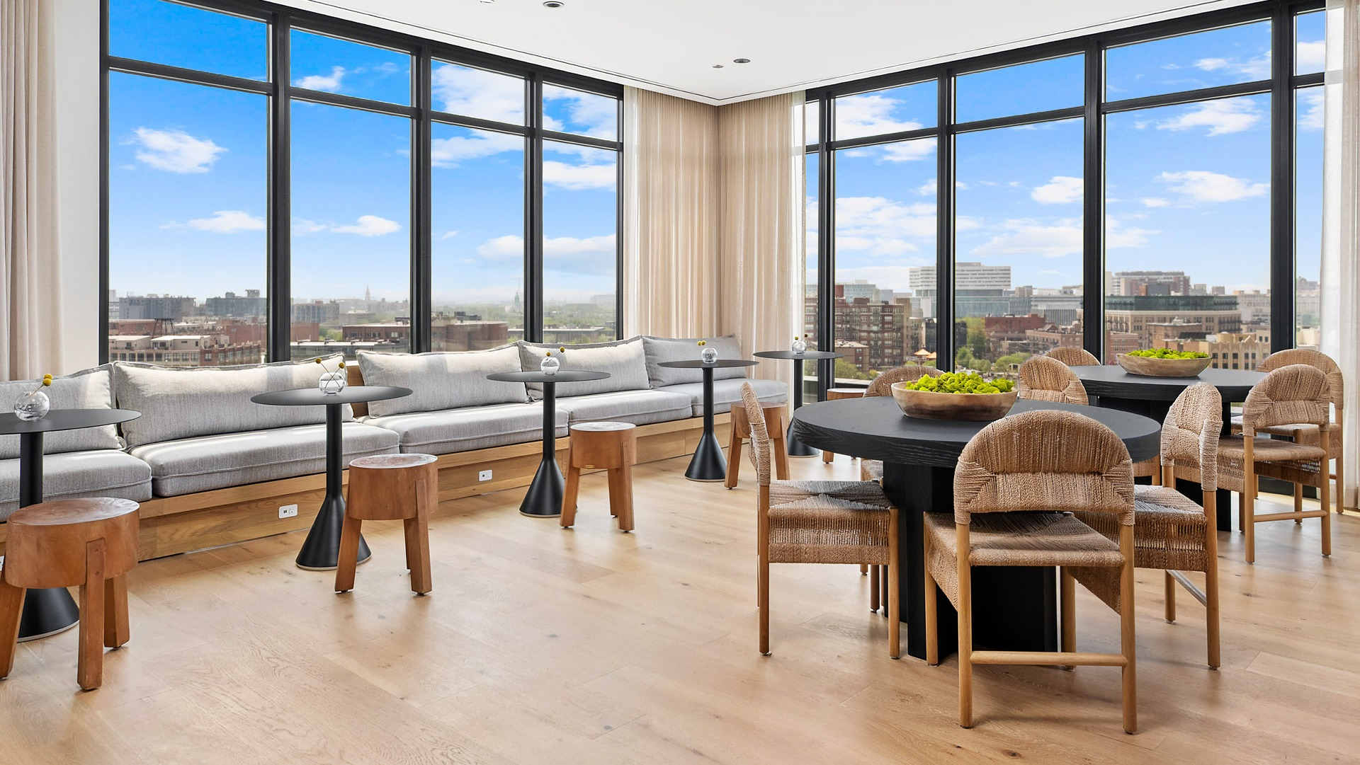 Elegant sky lounge at Evo Union Park in Chicago, offering plush seating, stylish decor, and expansive windows with breathtaking city views