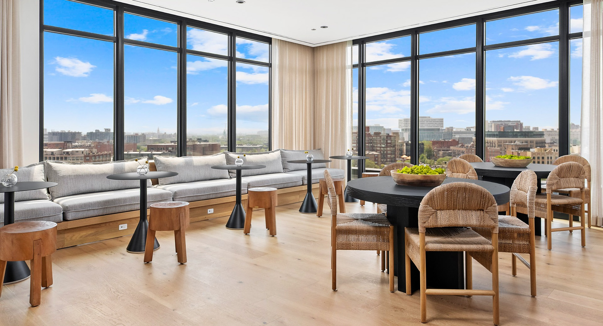 Elegant sky lounge at Evo Union Park in Chicago, offering plush seating, stylish decor, and expansive windows with breathtaking city views