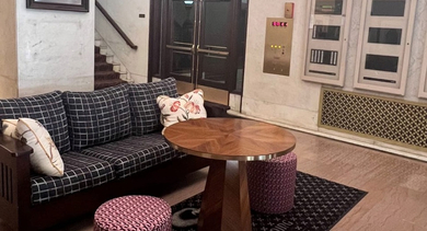 Grand lobby at Fisher Building Apartments in Chicago, featuring classic architectural details, comfortable seating, and historic charm