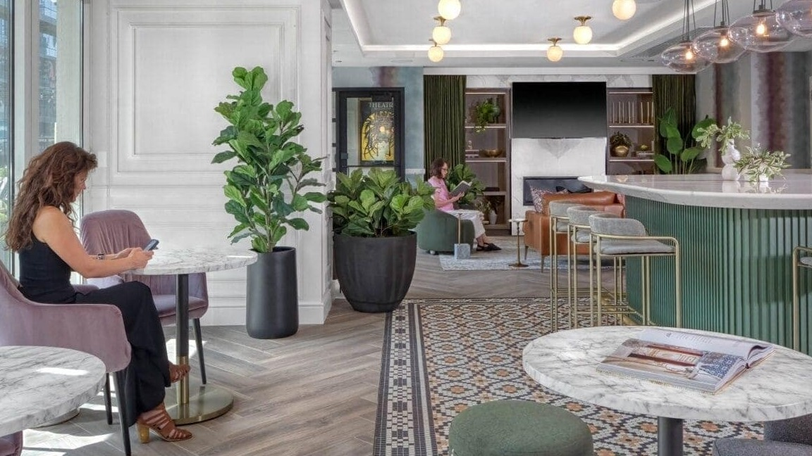 Chic resident lounge and café area at Flair Tower Apartments in Chicago, with stylish seating, modern decor, and a vibrant atmosphere