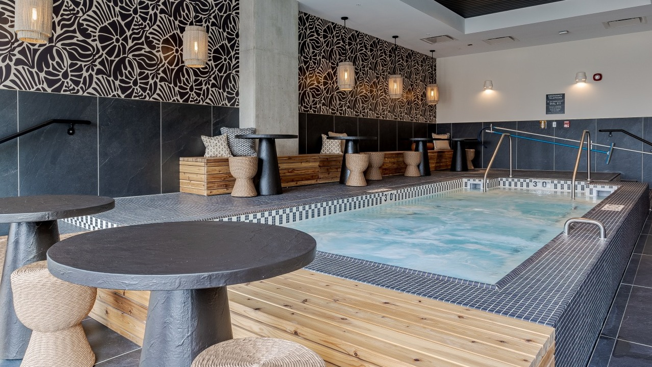 Relaxing indoor spa and hot tub area at Flora apartments in Chicago, with stylish decor and comfortable seating