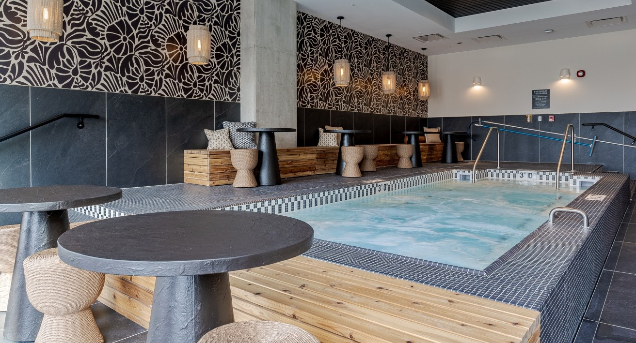 Relaxing indoor spa and hot tub area at Flora apartments in Chicago, with stylish decor and comfortable seating