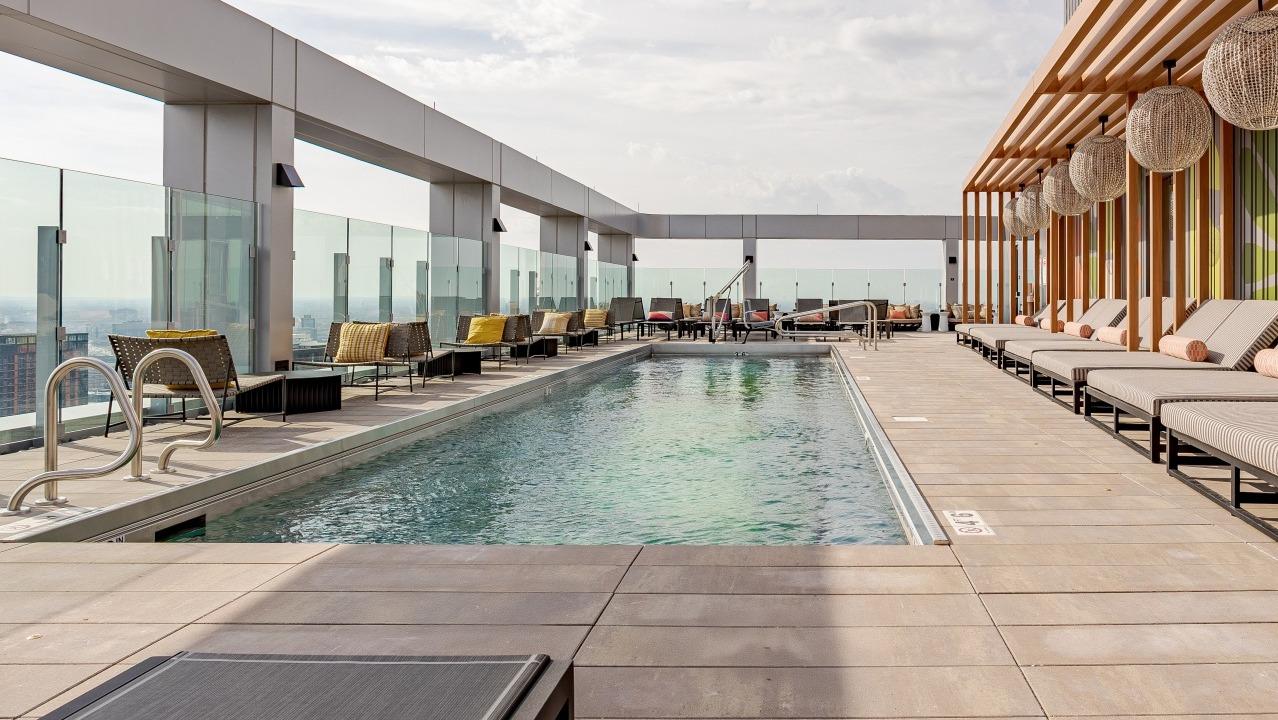 Serene rooftop pool at Flora apartments in Chicago, surrounded by comfortable loungers, cabanas, and modern design for ultimate relaxation