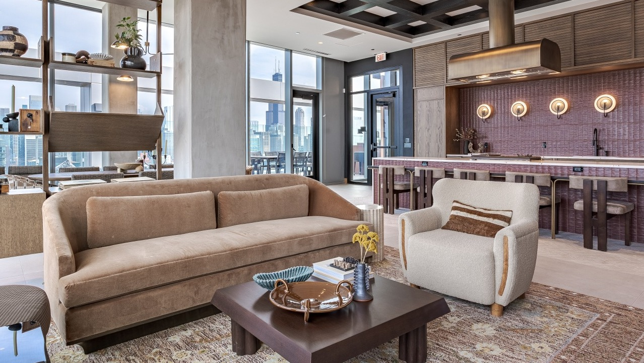 Sophisticated sky lounge and gourmet kitchen at Flora apartments in Chicago, offering luxurious seating and panoramic city views
