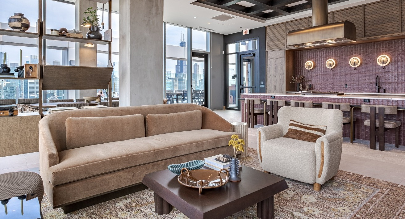 Sophisticated sky lounge and gourmet kitchen at Flora apartments in Chicago, offering luxurious seating and panoramic city views