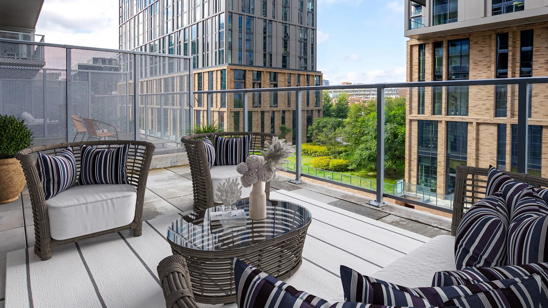 Spacious private balcony with comfortable outdoor seating and city park views at Gateway West Loop apartments in Chicago