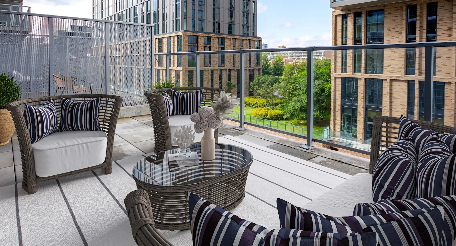 Spacious private balcony with comfortable outdoor seating and city park views at Gateway West Loop apartments in Chicago