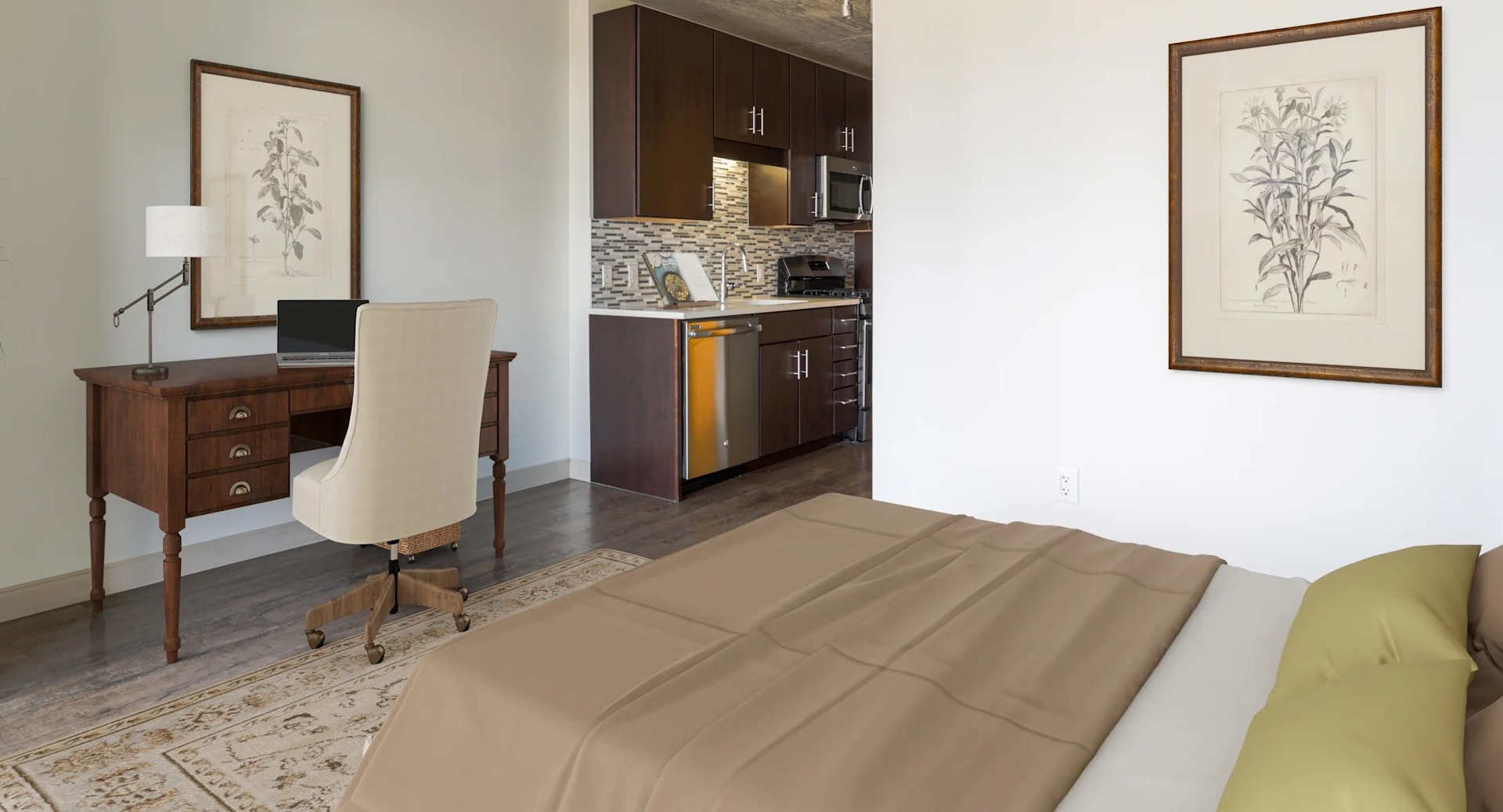 Cozy bedroom with a dedicated work-from-home office space and modern kitchen in the background at Gateway West Loop, Chicago