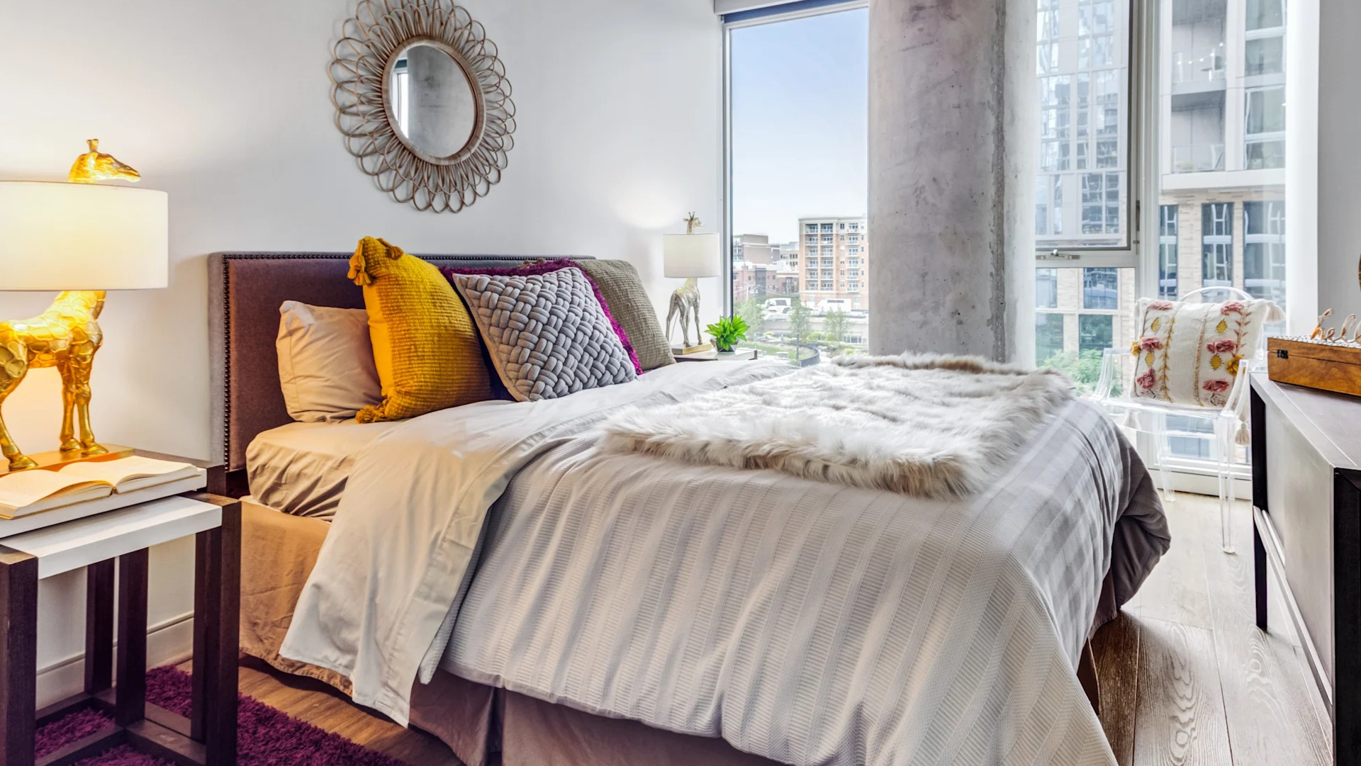 Cozy bedroom featuring a comfortable bed, large windows with city views, and chic decor at Gateway West Loop apartments, Chicago