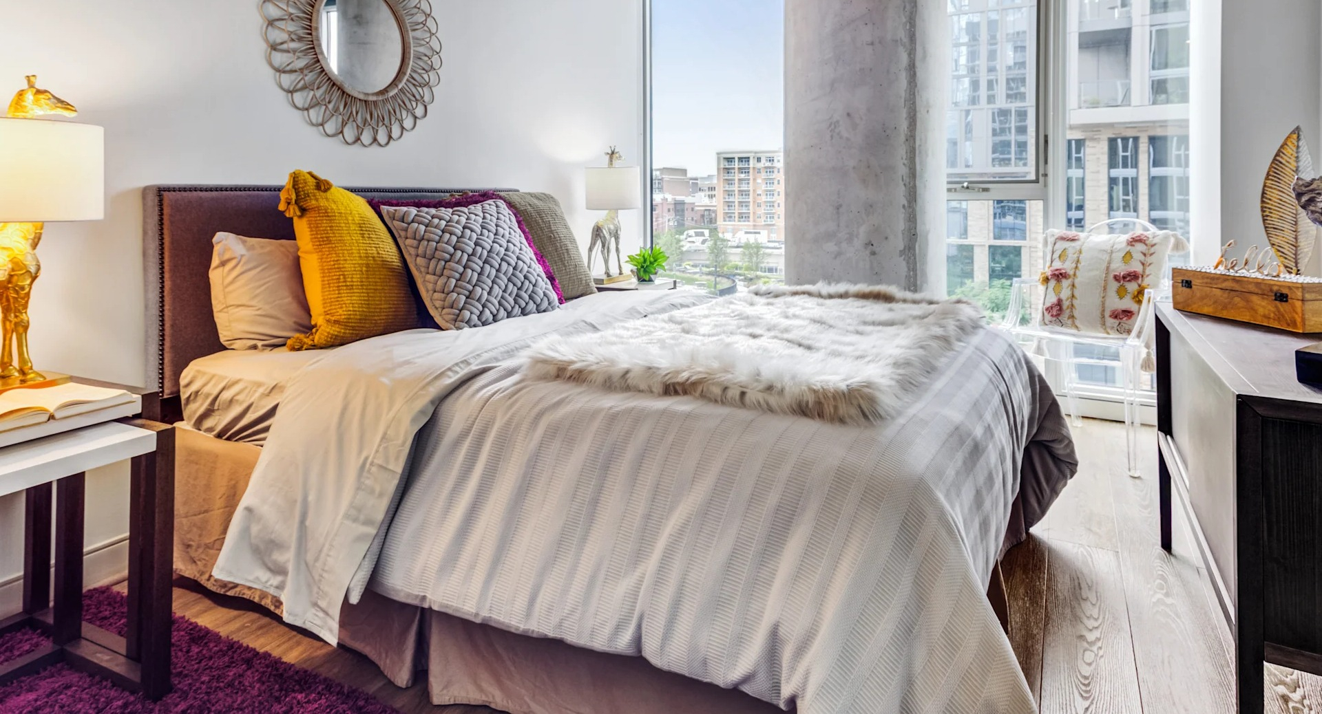 Cozy bedroom featuring a comfortable bed, large windows with city views, and chic decor at Gateway West Loop apartments, Chicago