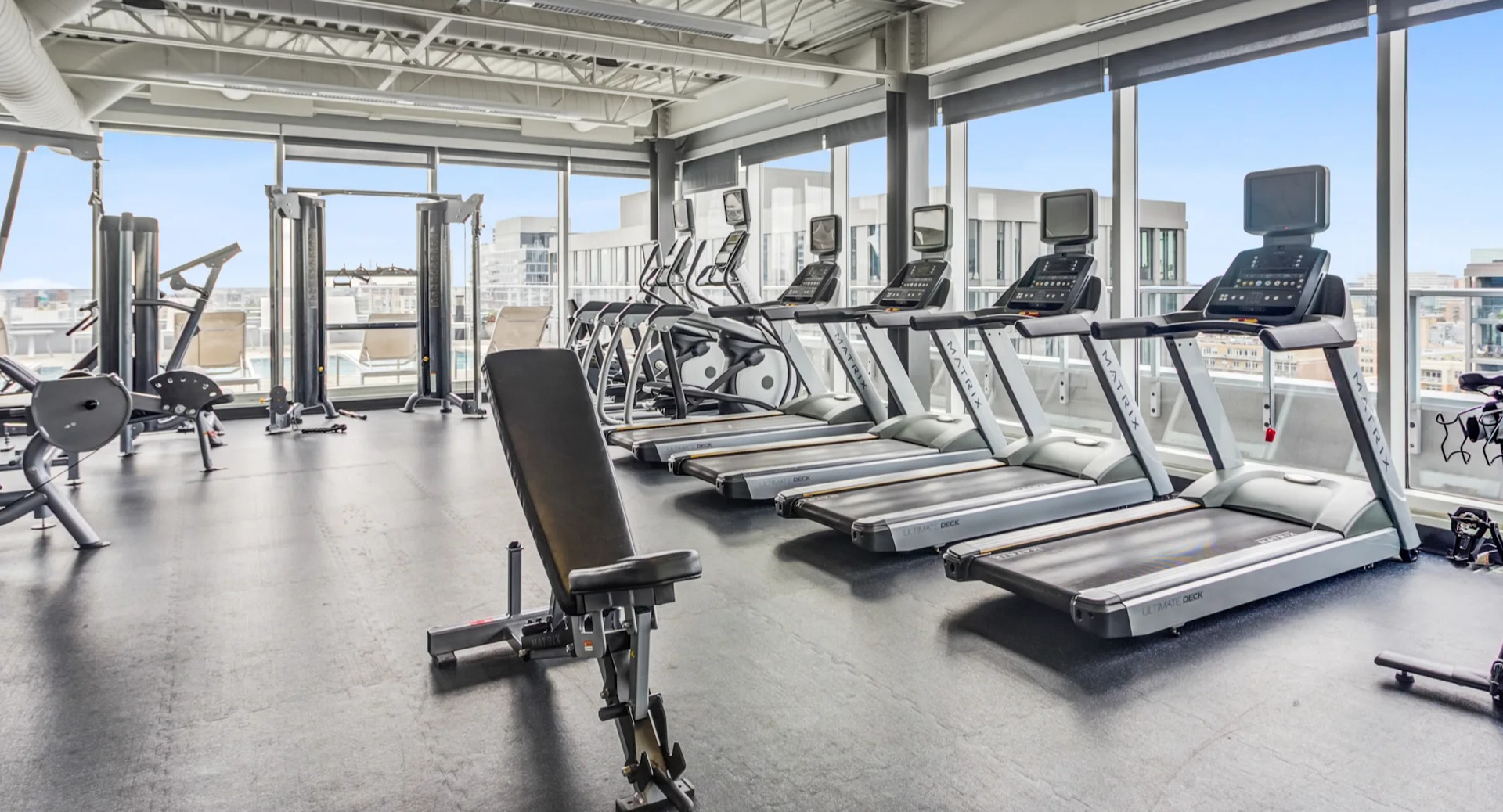 State-of-the-art fitness center featuring cardio machines and city views at Gateway West Loop apartments in Chicago