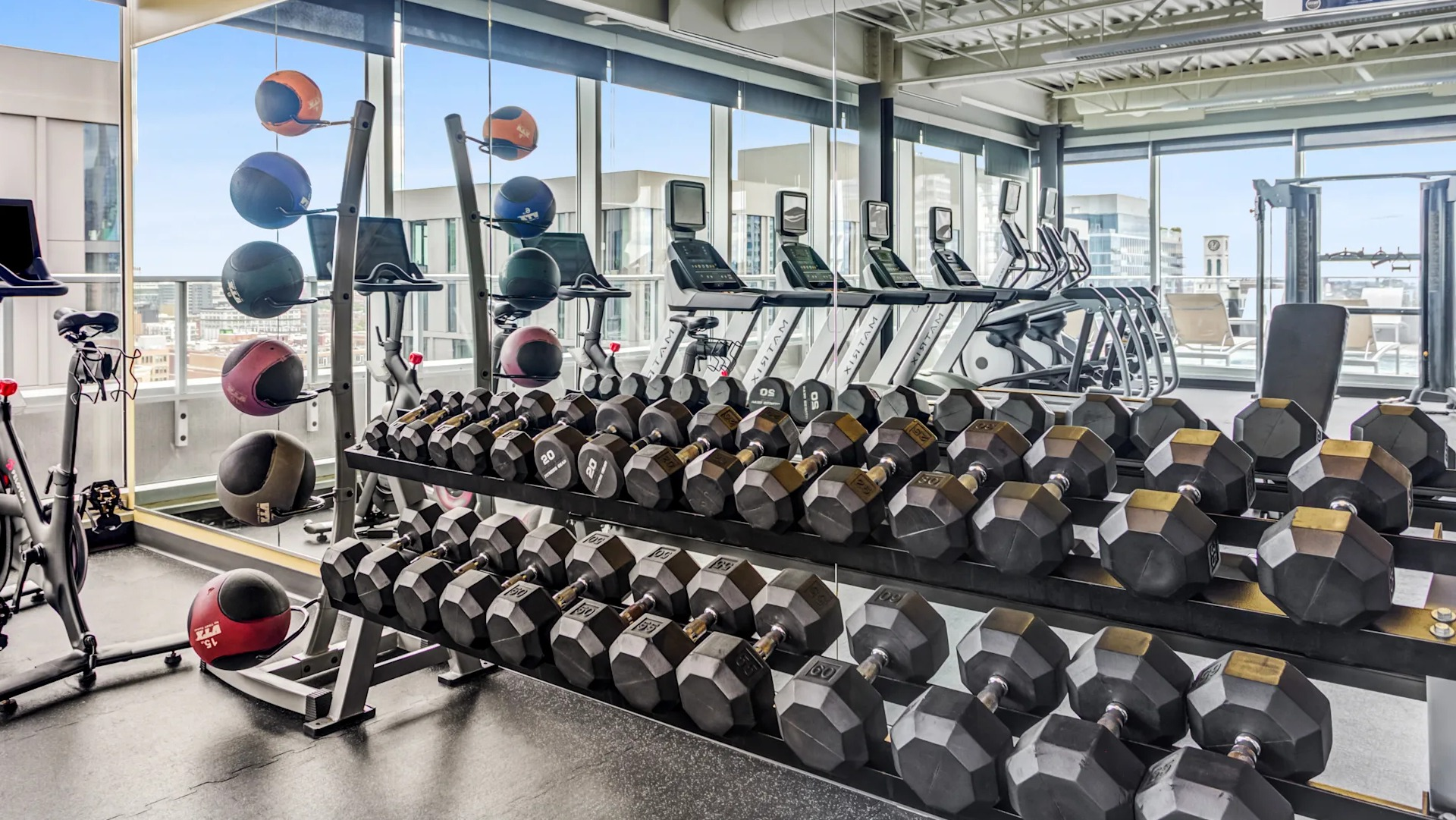 Well-equipped fitness center with a wide selection of free weights and exercise equipment at Gateway West Loop, Chicago