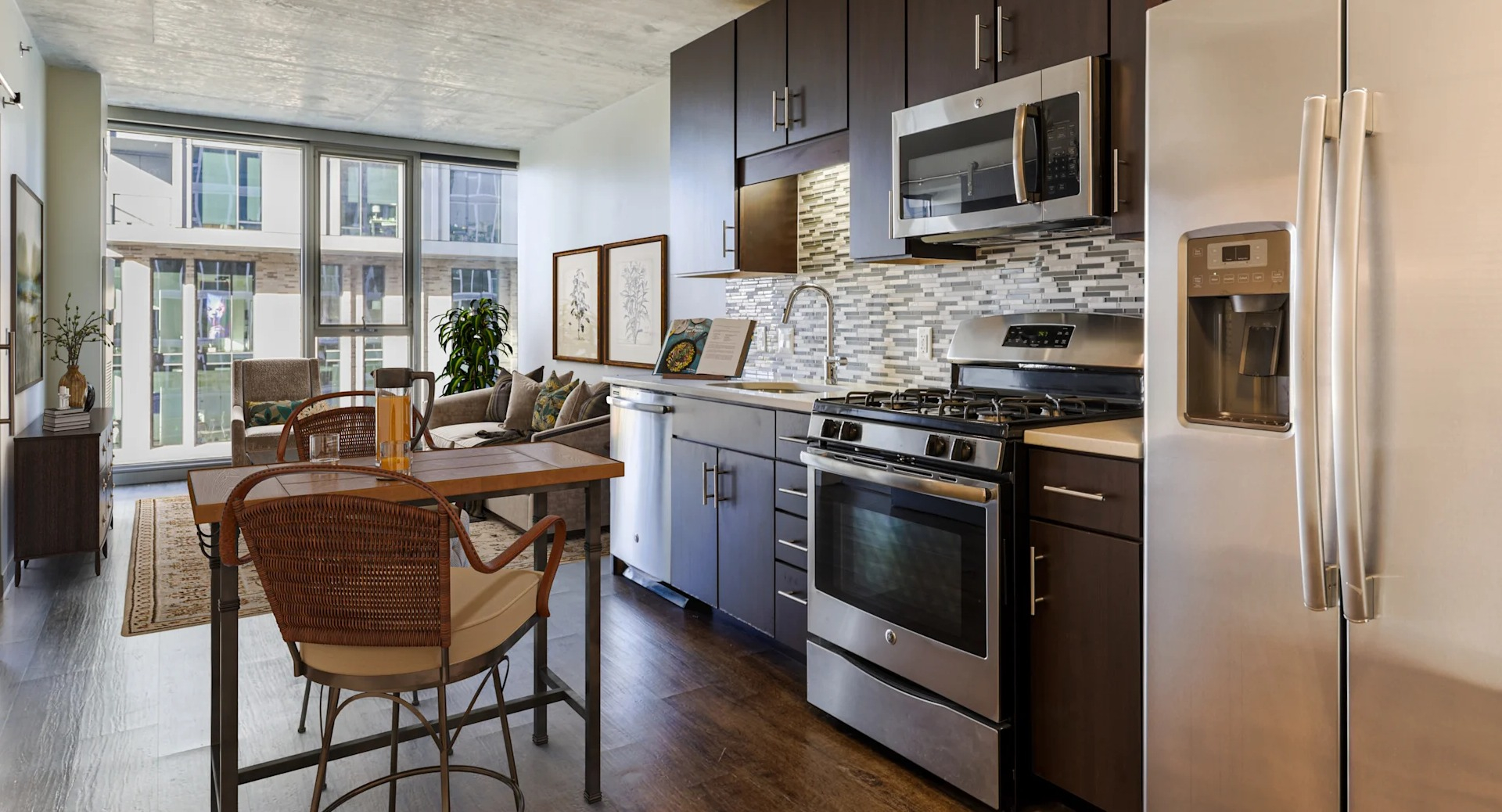 Open-concept kitchen and dining area featuring stainless steel appliances and city views at Gateway West Loop apartments in Chicago