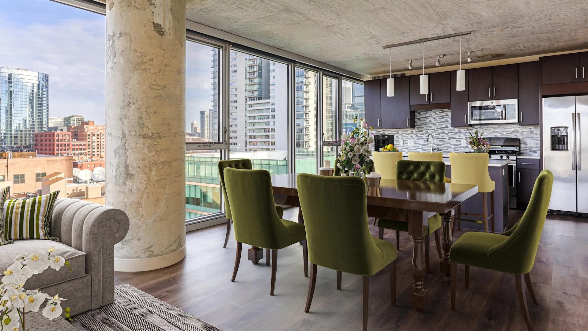 Open-concept living, dining, and kitchen area with stunning city views at Gateway West Loop apartments in Chicago