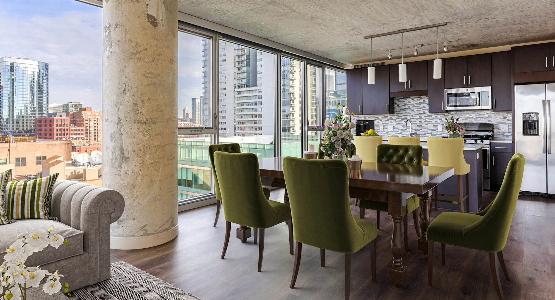 Open-concept living, dining, and kitchen area with stunning city views at Gateway West Loop apartments in Chicago