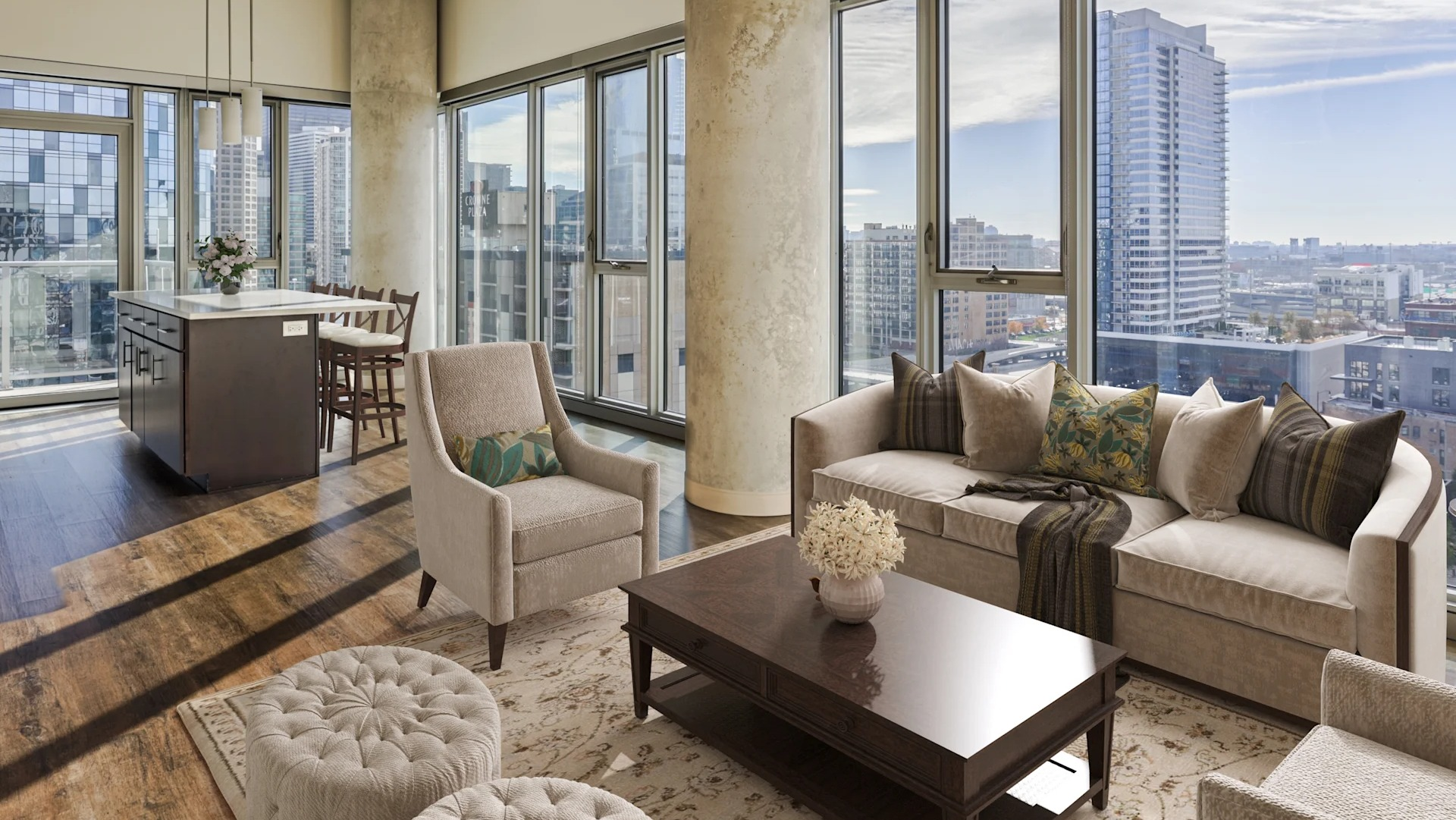 Spacious living room with comfortable seating, modern furnishings, and panoramic city views at Gateway West Loop, Chicago
