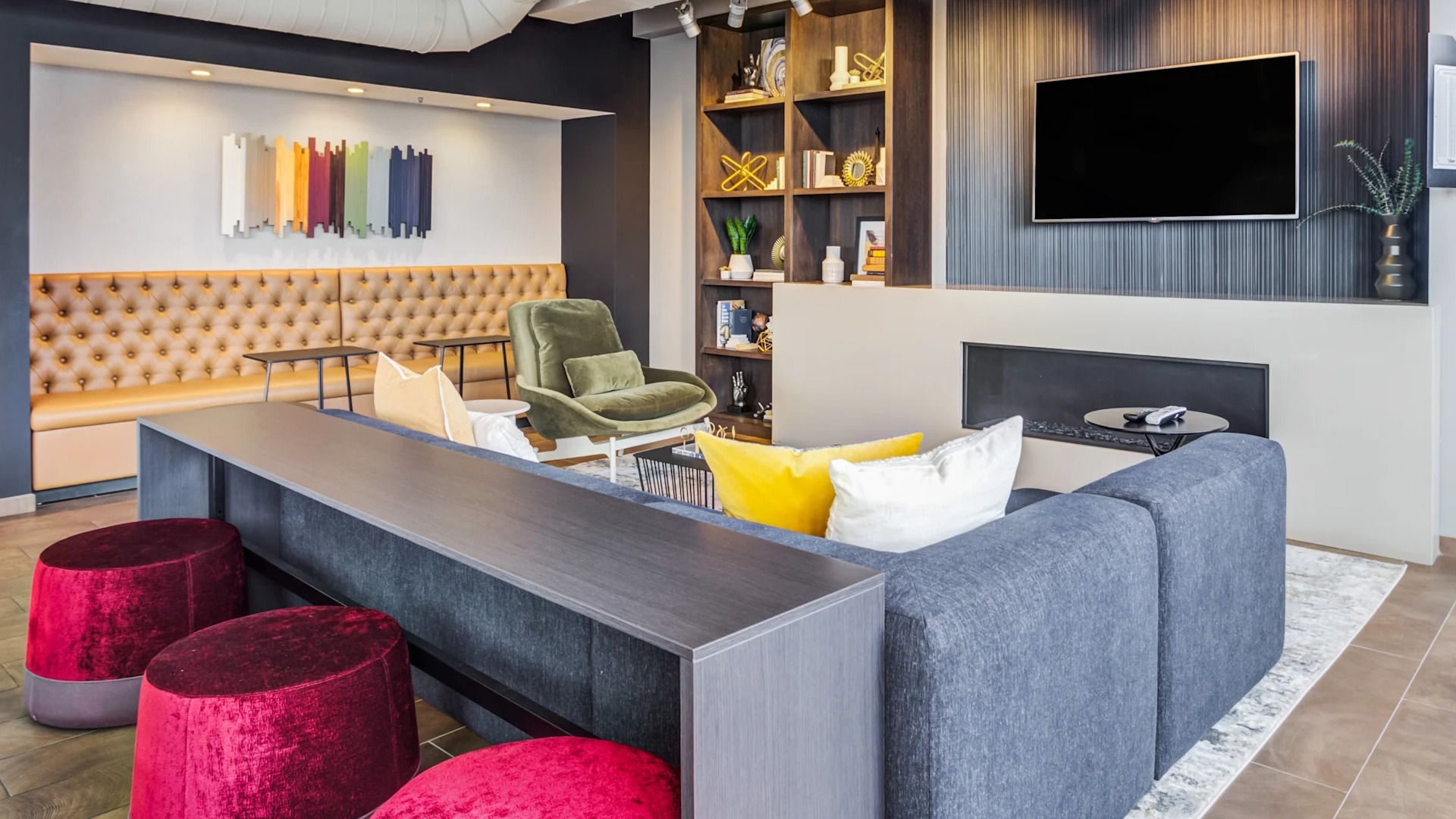 Inviting lounge area featuring a sleek fireplace, comfortable seating, and a dartboard at Gateway West Loop apartments, Chicago
