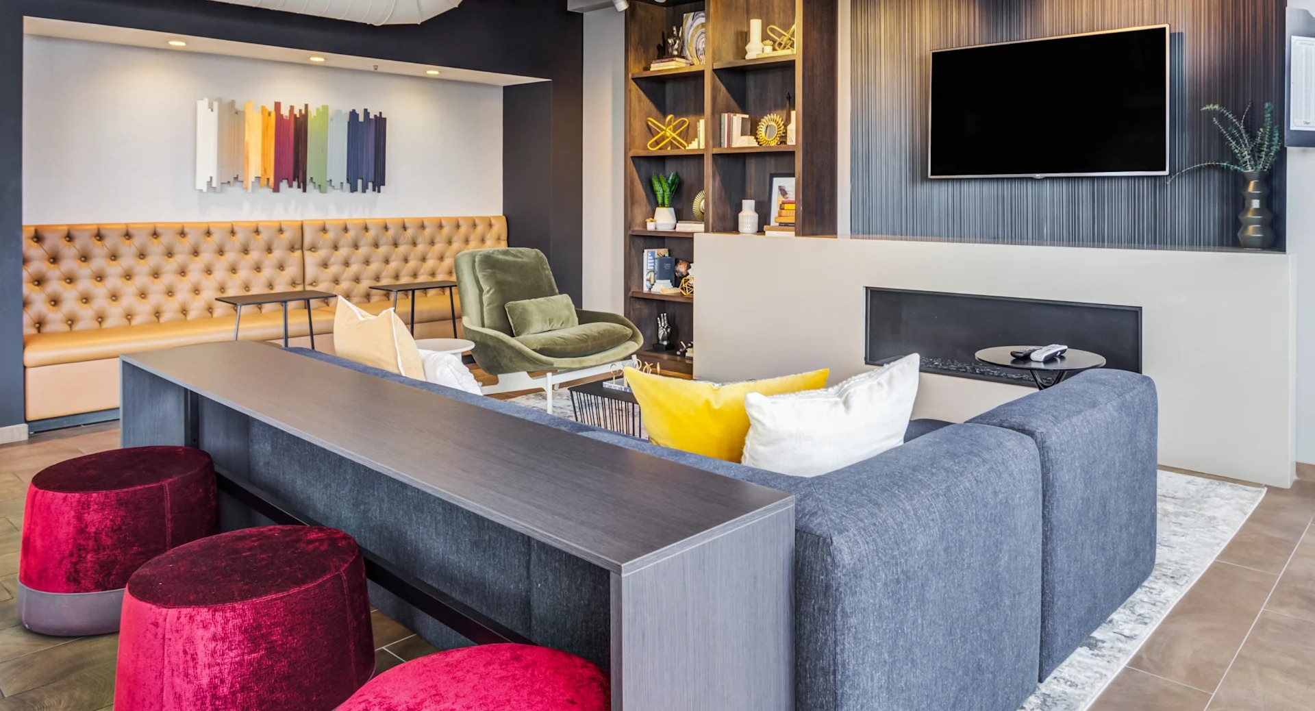 Inviting lounge area featuring a sleek fireplace, comfortable seating, and a dartboard at Gateway West Loop apartments, Chicago