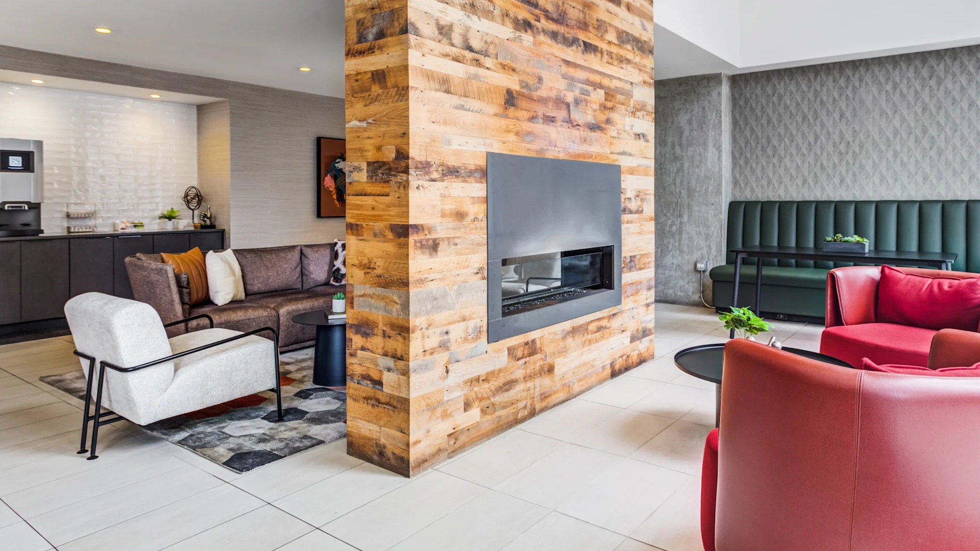 Stylish lounge area with a modern fireplace and comfortable seating, ideal for relaxing at Gateway West Loop in Chicago