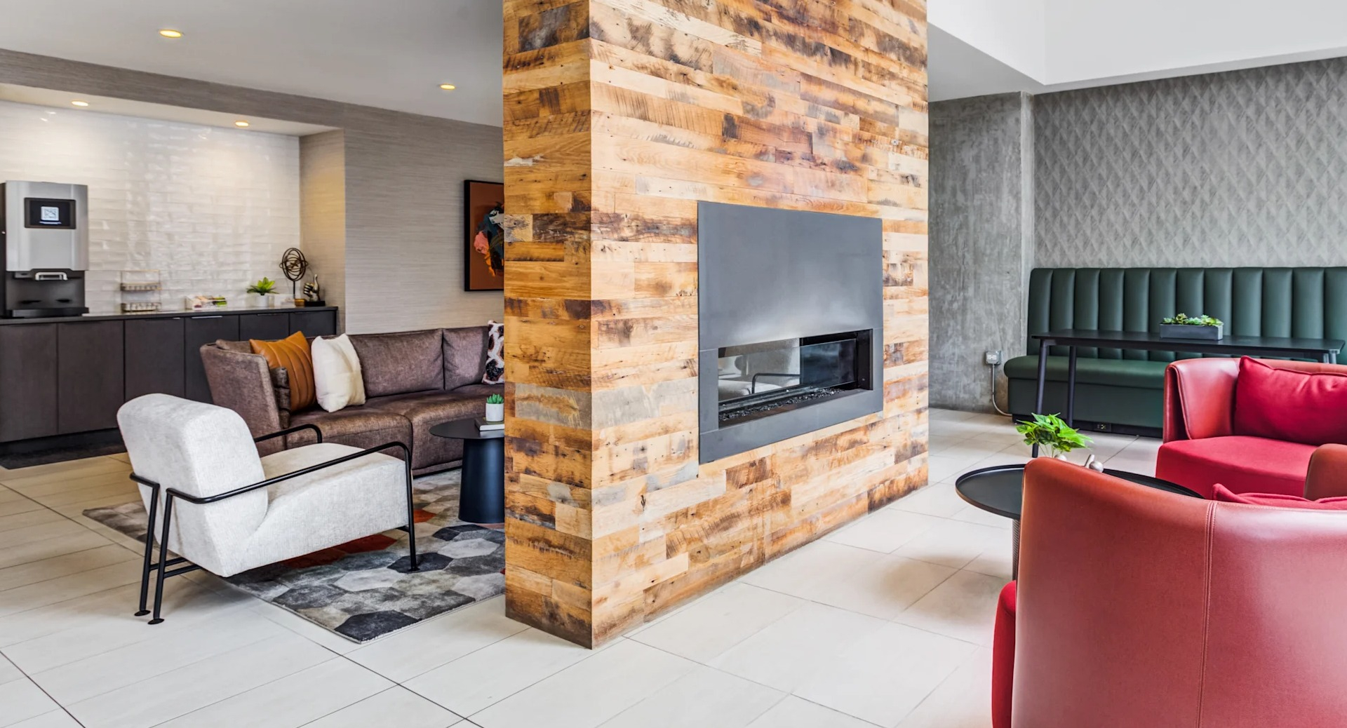 Stylish lounge area with a modern fireplace and comfortable seating, ideal for relaxing at Gateway West Loop in Chicago
