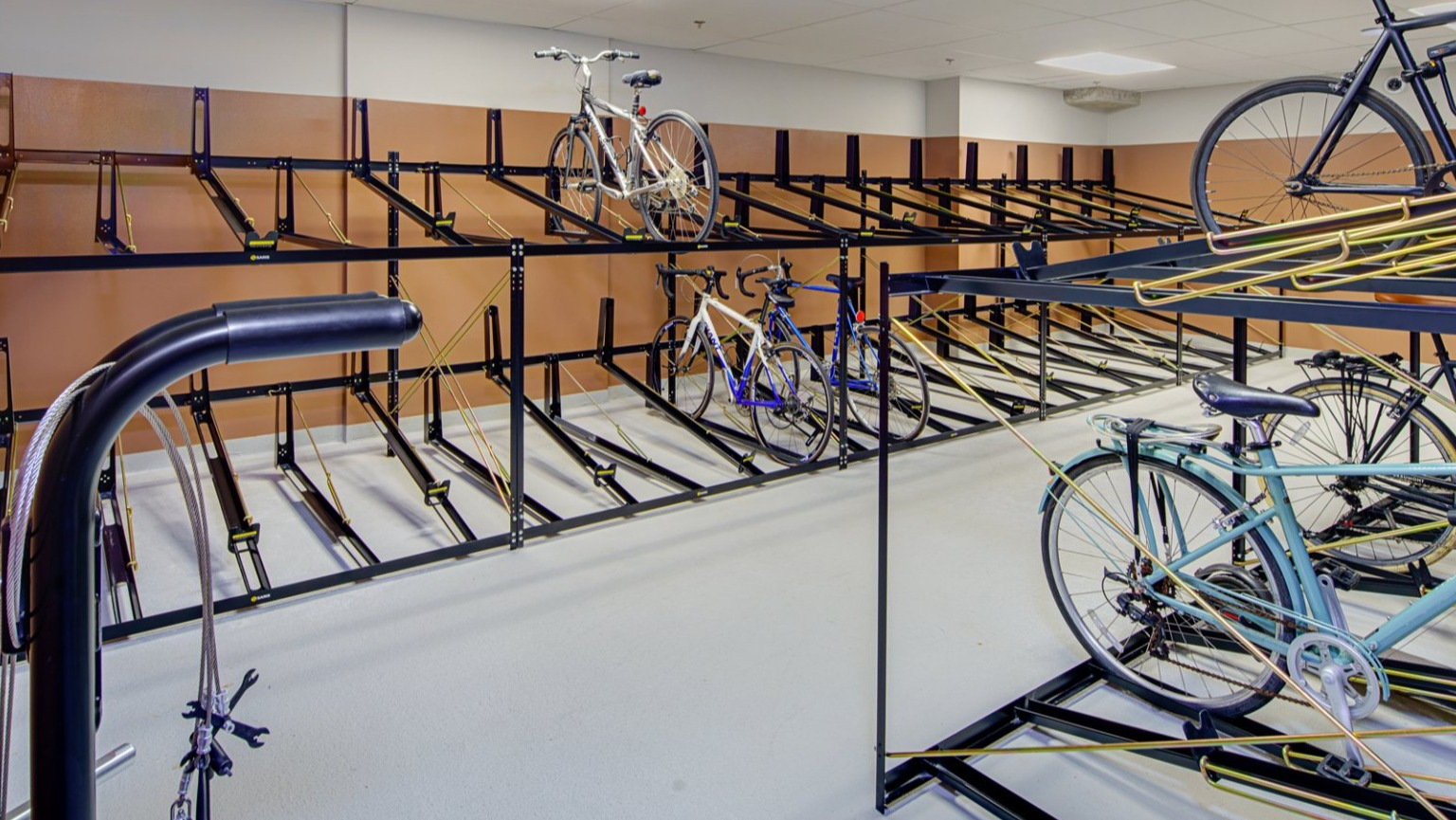 Organized bike room with multiple storage racks, providing ample space for resident bicycles at Gild apartments in Chicago