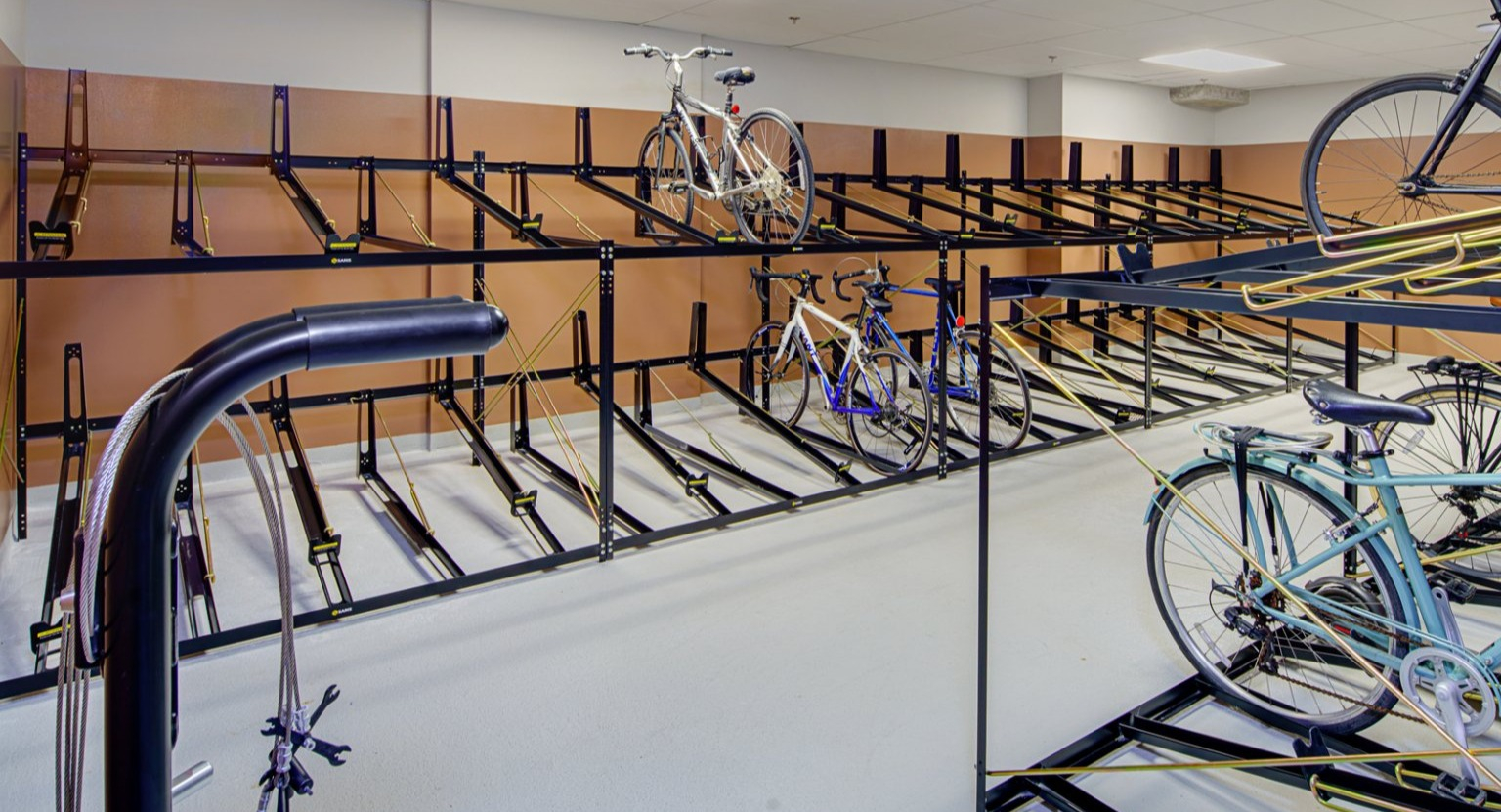 Organized bike room with multiple storage racks, providing ample space for resident bicycles at Gild apartments in Chicago