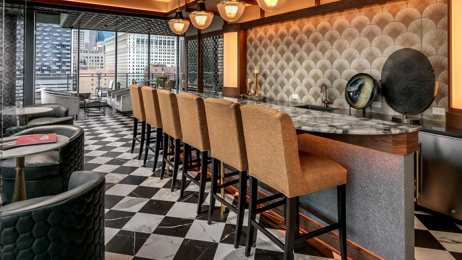 Chic bar and lounge area at The Grand Central Apartments in Chicago, featuring stylish seating, unique decor, and city views