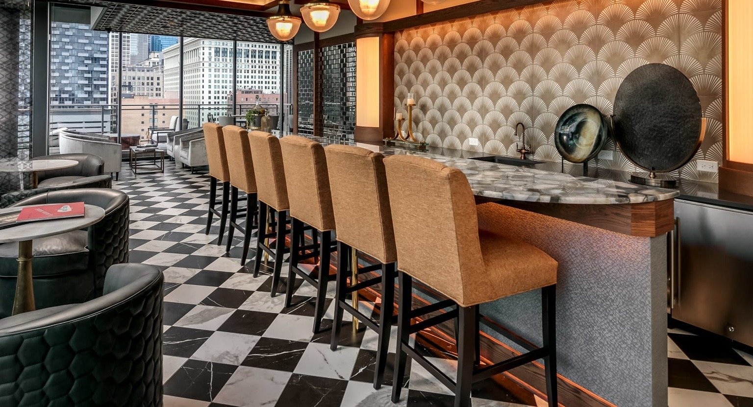 Chic bar and lounge area at The Grand Central Apartments in Chicago, featuring stylish seating, unique decor, and city views