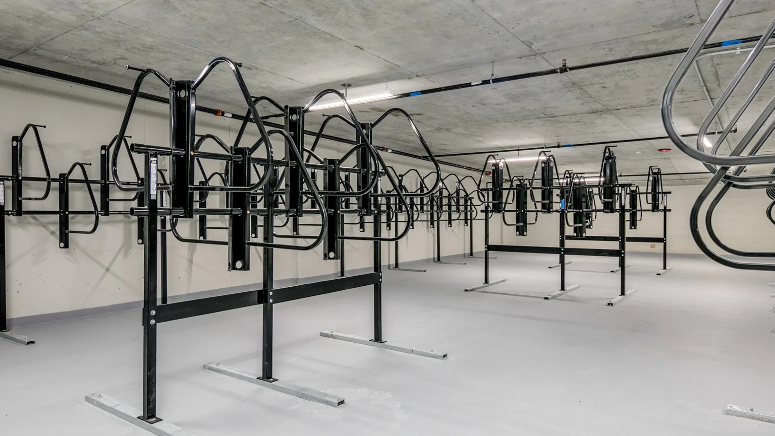 Secure and spacious bike storage room at The Grand Central Apartments in Chicago, offering ample racks for residents' bicycles