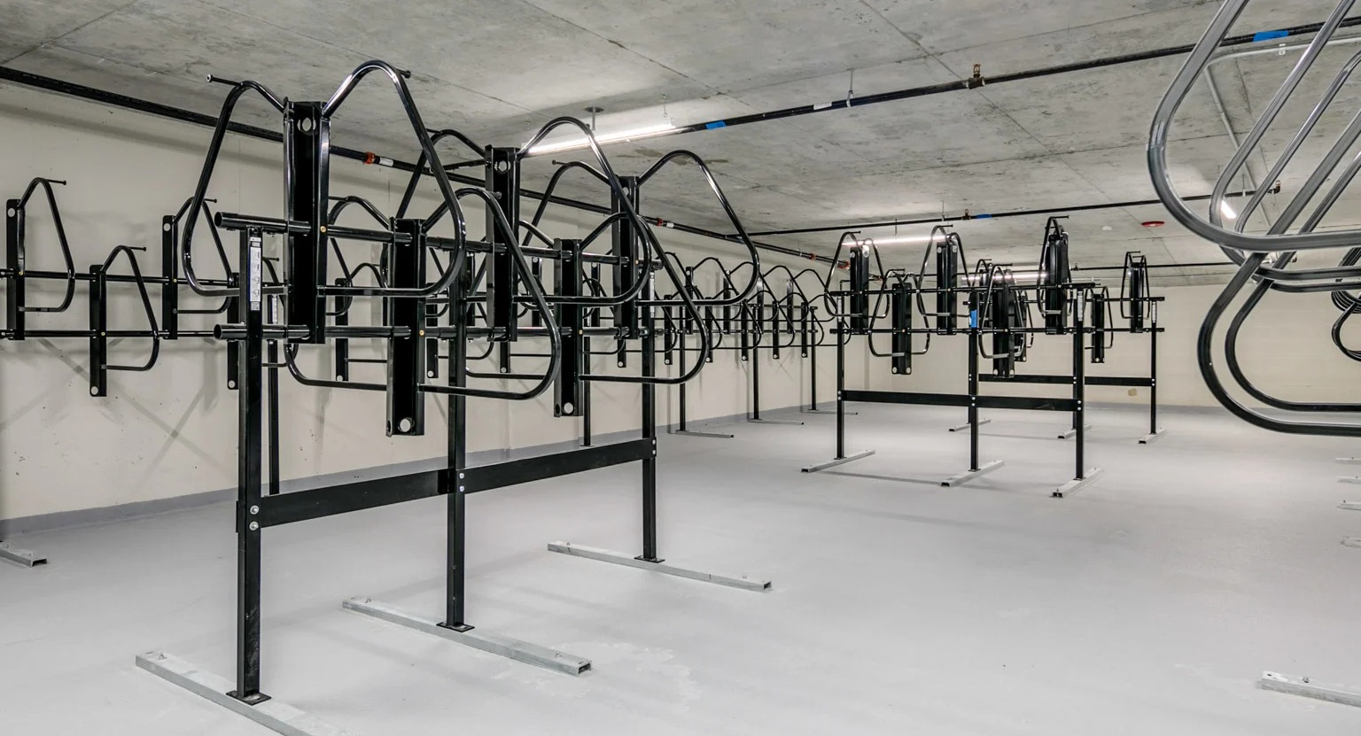 Secure and spacious bike storage room at The Grand Central Apartments in Chicago, offering ample racks for residents' bicycles